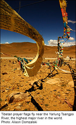 Tibetan prayer flags fly near the Yarlung Tsangpo River, the highest major river in the world.