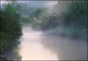 Misty peaceful river in morning fog Vermont New England