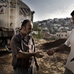 A family pays for emergency water from a tanker.