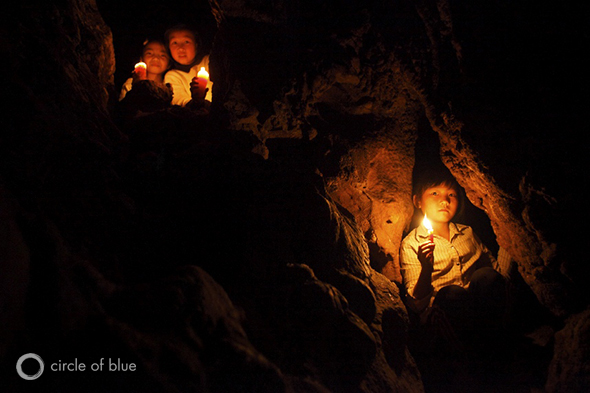 Schoolgirls perch in the caverns of Yuan Shi Dong, the Fate Lion Cave, where a Buddhist temple stands