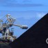 A coal loader eats away at a mountain of black coal at the Port of Newcastle in New South Wales, Australia. In 2011, the mines, trains, and coal loading terminals here shipped about 114 million metric tons of coal on about 1,000 freighters, bringing billions of dollars in export earnings.