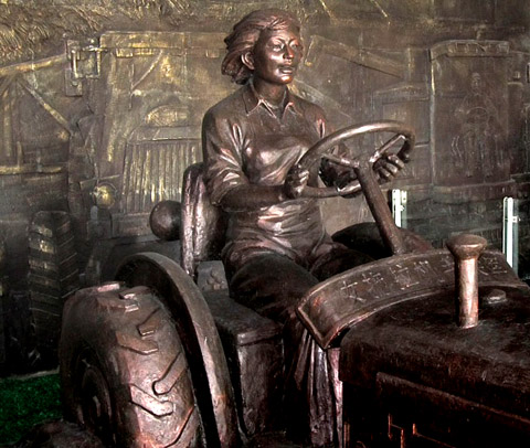 A bronze state of Liang Jun, the first Chinese woman to drive a tractor in the 1950s. hongxinglong liang jun tractor bronze statue soviet union era food water energy Choke Point China Circle of Blue Keith Schneider