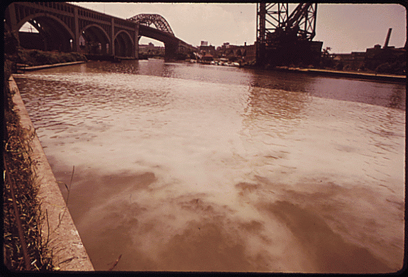 Sewage is discharged in the Cuyahoga River near Cleveland, Ohio in this 1973 photograph. The Clean Water Act, passed a year earlier, has improved water quality in many water bodies, but some communities still struggle to control water pollution from combined sewer systems.