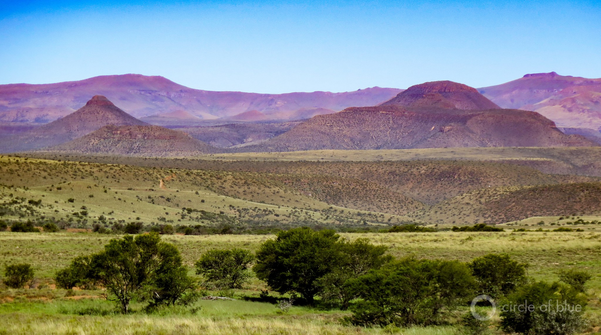  Thinly populated, with towns hours distant from one another, the Karoo’s hot desert extends to the sides of mammoth tabletop ridges that turn purple at dusk. This canvas of color and light, of rock and mountain and glorious sunsets, has inspired generations of South African poets and artists. Photo © Keith Schneider / Circle of Blue