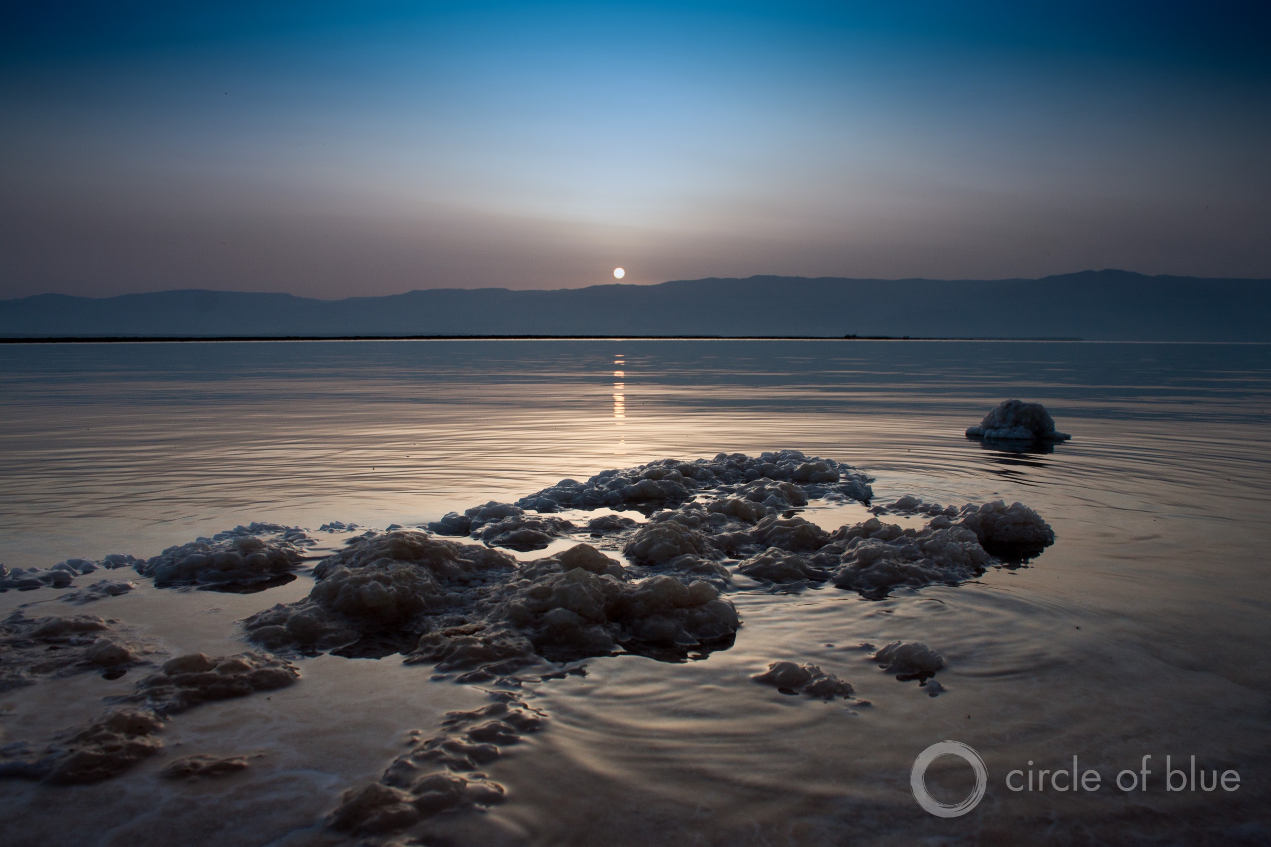 Sunrise over the Dead Sea is veiled by haze. Halting the decline of the shrinking sea is a top water policy question in the Jordan River Basin. Photo © Brett Walton / Circle of Blue