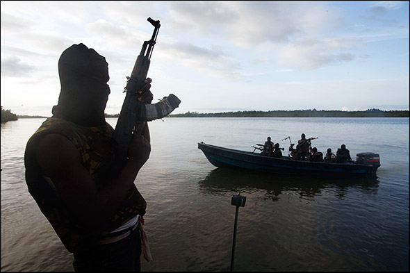 Members of the militant group MEND patrol the water of the Niger Delta. The river and streams serve as the primary fighting ground for the group. Photo by Ed Kashi.