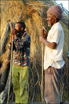Nyare Bapalo and his grandnephew Moagi sharpening spears before a hunt