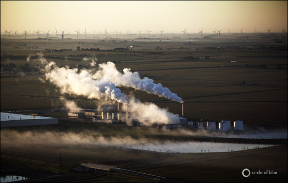 ROCHELLE, ILLINOIS, AUGUST 2010: The Illinois River Energy biofuels plant in Rochelle releases plumes of steam at sunrise. The ethanol plant processes over 40 million bushels of corn into 115 million gallons of fuel grade ethanol annually.  The plant is one of hundreds around the country transforming corn into ethanol. It takes nearly 1,000 gallons of water to produce a gallon of ethanol from irrigated corn: four gallons from unirrigated corn.