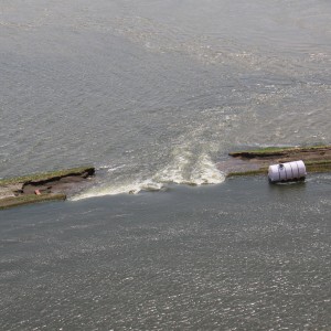 An aerial view of an intentional breach in levee L-575 near Hamburg, Iowa, June 20. The intentional breach was created by the local sponsor and approved by the U.S. Army Corps of Engineers following a full breach of the levee June 13. The intentional breach was conducted by the sponsor to delay the time in which the area behind the levee would flood. The levee is located at River Mile 552 in Atchison County, Mo. (U.S. Army Photo)