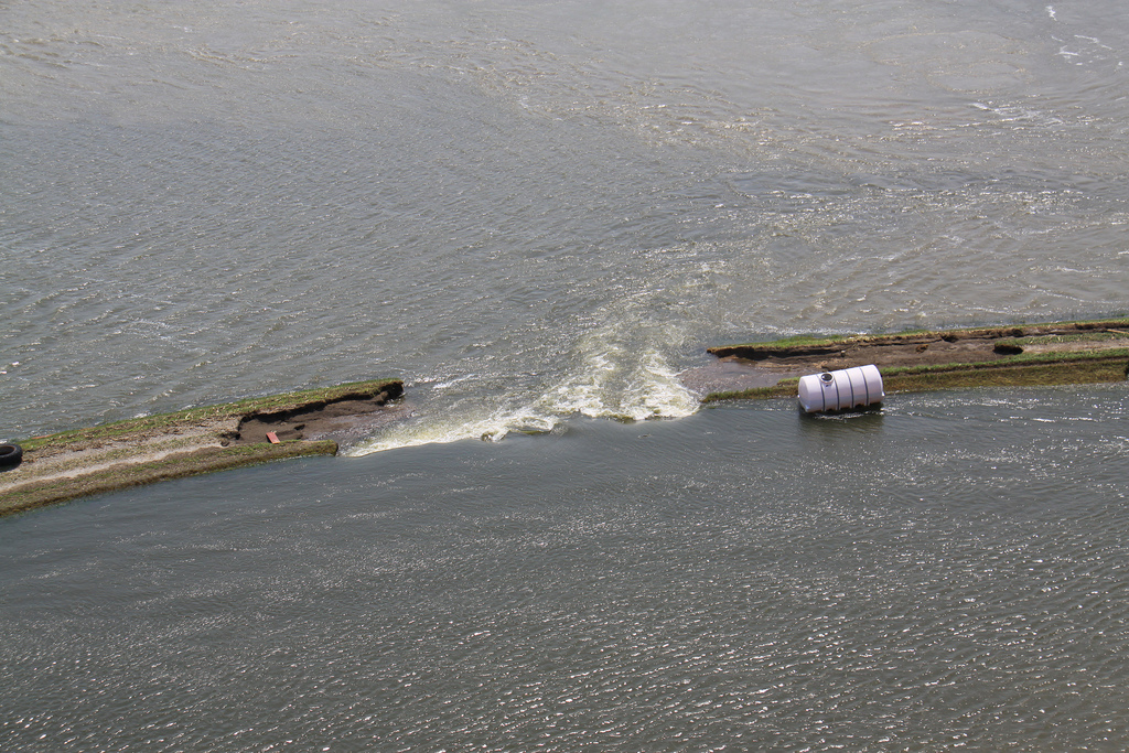 An aerial view of an intentional breach in levee L-575 near Hamburg, Iowa, June 20. The intentional breach was created by the local sponsor and approved by the U.S. Army Corps of Engineers following a full breach of the levee June 13. The intentional breach was conducted by the sponsor to delay the time in which the area behind the levee would flood. The levee is located at River Mile 552 in Atchison County, Mo. (U.S. Army Photo)