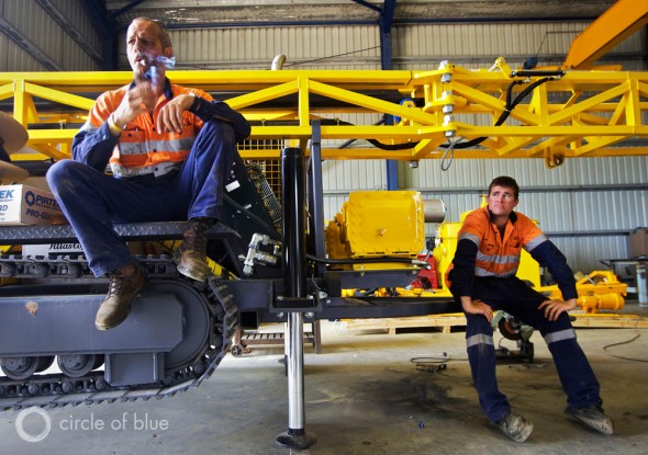 Two Atlas Copco employees take a quick break from assembling coal exploration equipment in a warehouse outside of Muswellbrook, Australia.