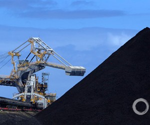 A coal loader eats away at a mountain of black coal at the Port of Newcastle in New South Wales, Australia. In 2011, the mines, trains, and coal loading terminals here shipped about 114 million metric tons of coal on about 1,000 freighters, bringing billions of dollars in export earnings.