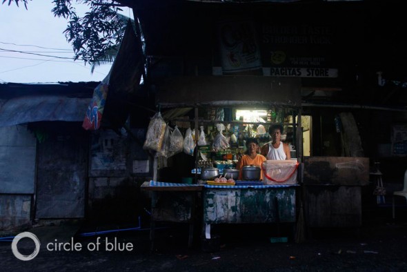 Small shops like Pacita’s Store in Cuatro, a poor “informal” community” in Manila’s east zone, open before dawn to feed residents as they head to work.