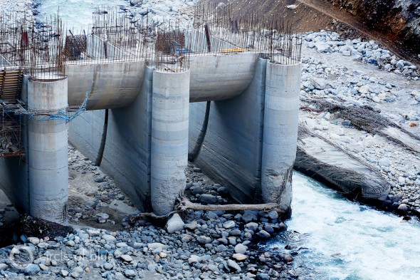 The 99-megawatt Singoli-Bhatwari Hydroelectric Project on the Mandakini River near Okund was so aggressively pummeled by floodwaters and boulders that big chunks of concrete were gouged out of its base and the patches of steel reinforcing rods of two support towers were bent like broken fingers. Photo: Dhruv Malhotra