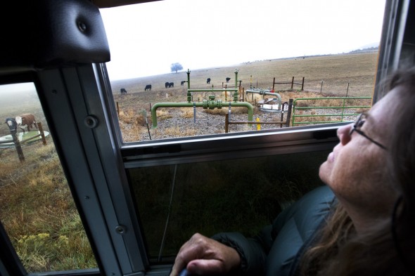 Lorie Syme (60) of Montrose — a small city with just over 40,000 people — looks out at a gas pipeline valve in Battlement Mesa during a tour of drilling sites led by Western Colorado Congress. Syme went on the tour because she wanted to learn more about the natural gas boom that has taken place in Colorado and across the country in recent years.