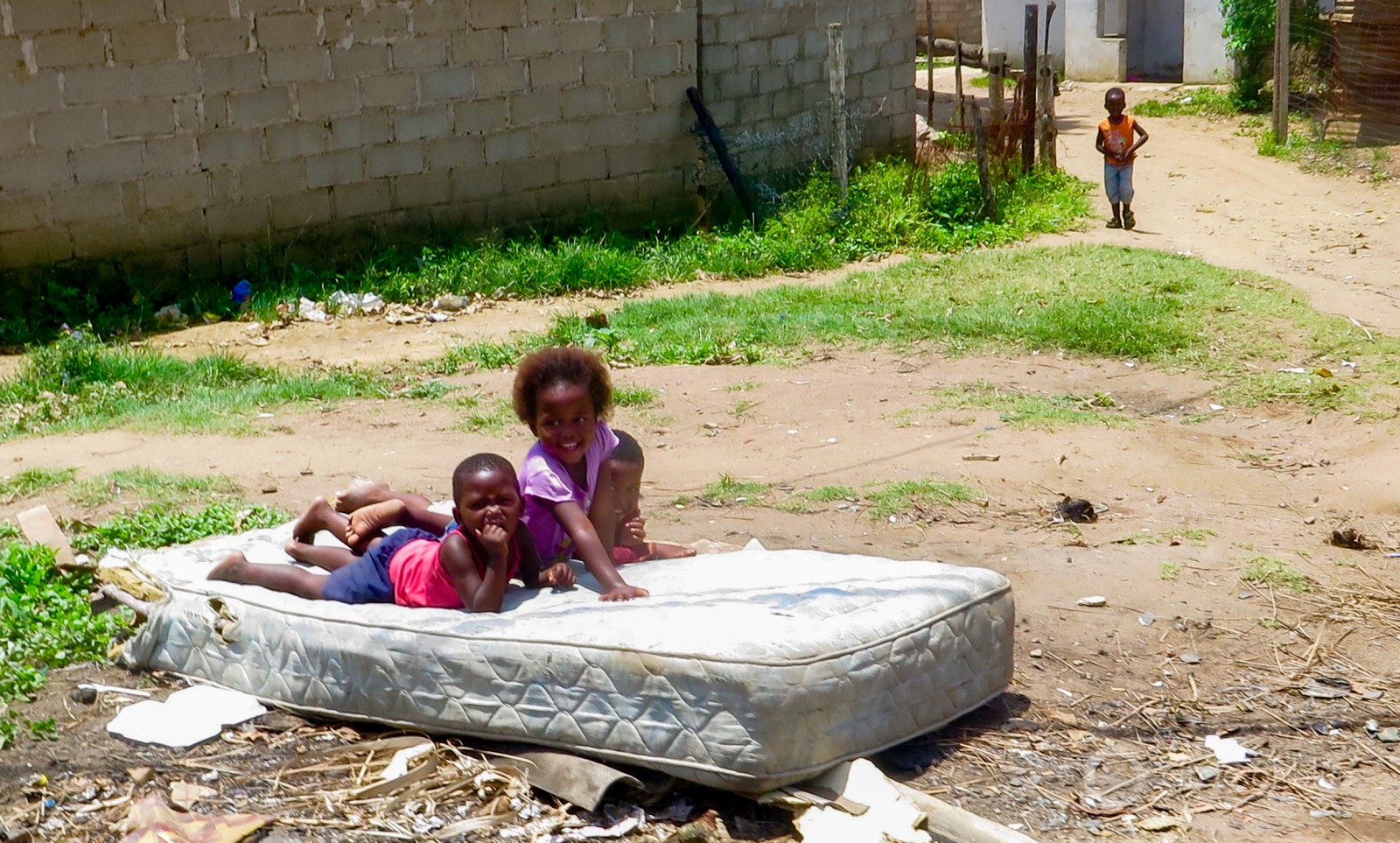 Children playing on a mattress at an informal settlement in Durban.