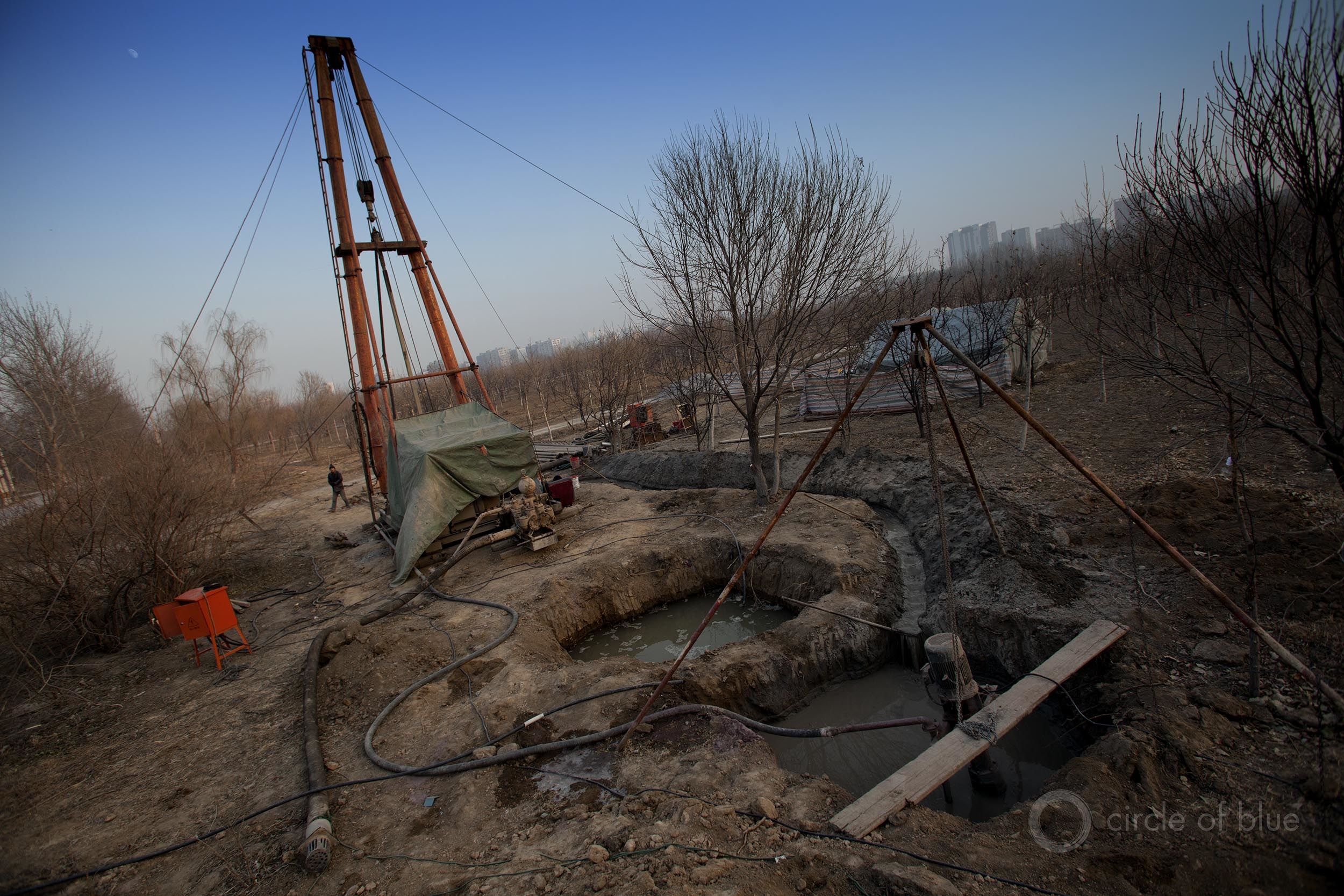 A community in Hebei Province, just outside of Beijing, drills for water to replace a dry well. The proliferation of such wells in the Beijing region is causing the land to sink, a process called subsidence. Photo © Aaron Jaffe / Circle of Blue