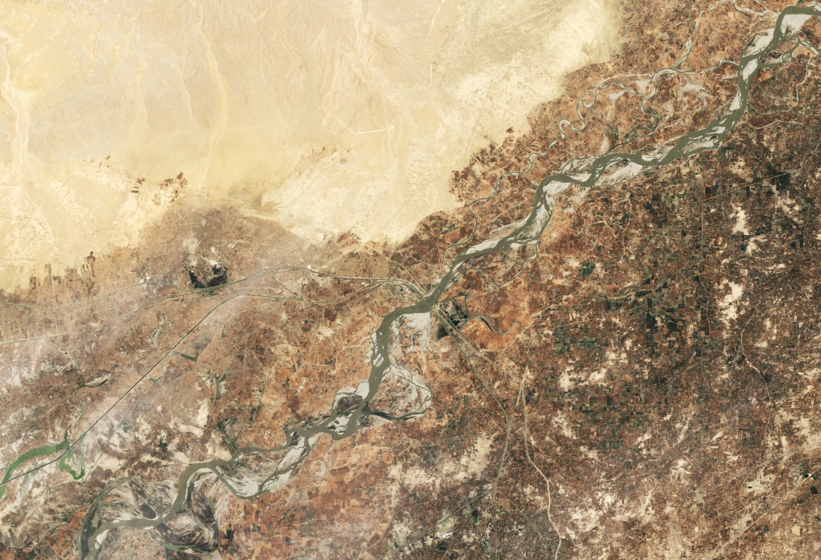 The Indus River is critical for agriculture and energy production in India and Pakistan. The shared river basin is home to at least 300 million people, and its water resources have long been a point of contention between the two countries. This image, captured by the Landsat 5 satellite in June 2009, shows the area around the Guddu Barrage, just south of the border between Punjab and Sindh provinces in Pakistan. Image courtesy NASA